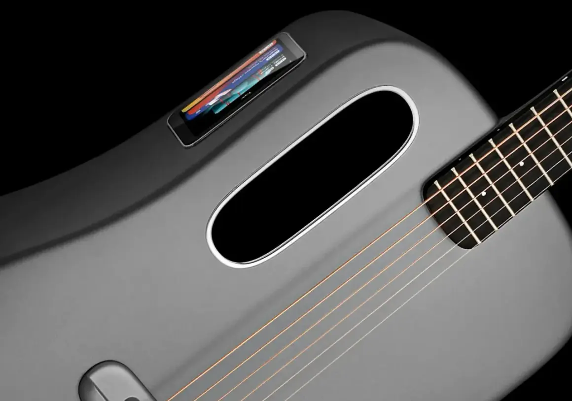 Moderne, graue Klampfe Gitarre mit integriertem Touchscreen und ovalem Schallloch.