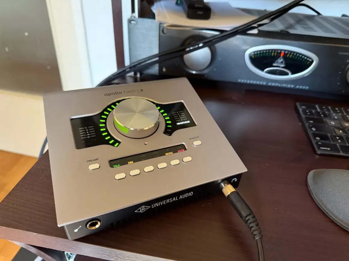 Universal Audio Apollo Twin X Audio-Interface auf einem Schreibtisch, bereit für Aufnahmen.