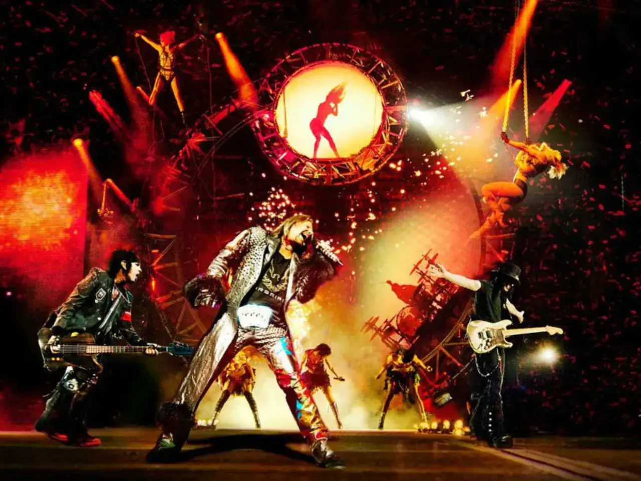 Rockbands der 80er live auf der Bühne: Sänger, Gitarristen und Tänzerinnen in einem Spektakel aus Licht und Konfetti.